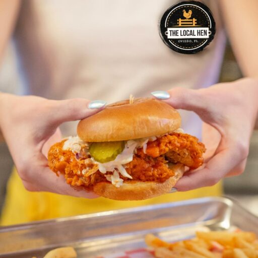 Buffalo Chicken Sandwich in hand _The Local Hen _ Food Factory Oviedo
